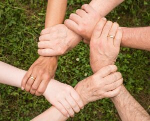 People linking wrists together in a circle