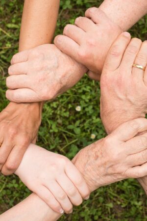 People linking wrists together in a circle